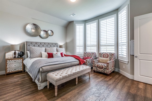 bedroom with dark hardwood / wood-style floors and vaulted ceiling