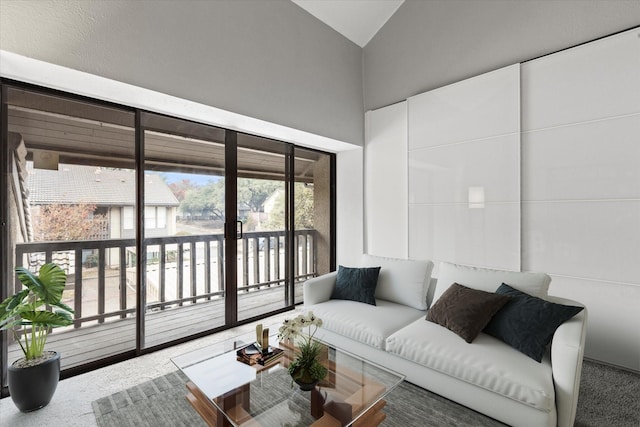 carpeted living room featuring vaulted ceiling