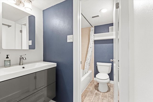 full bathroom with hardwood / wood-style flooring, vanity, toilet, and shower / bath combo with shower curtain