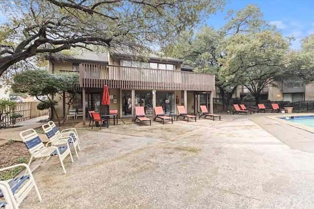 back of house featuring a patio area and a community pool