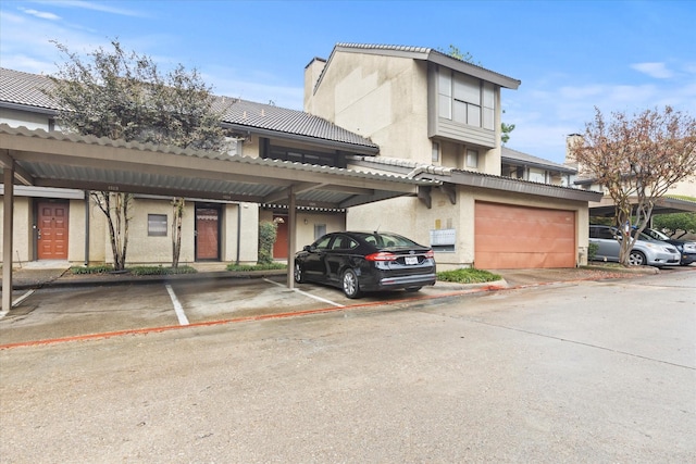 view of front of house with a carport and a garage