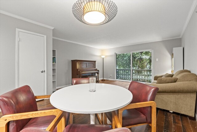 dining area featuring dark hardwood / wood-style floors and ornamental molding