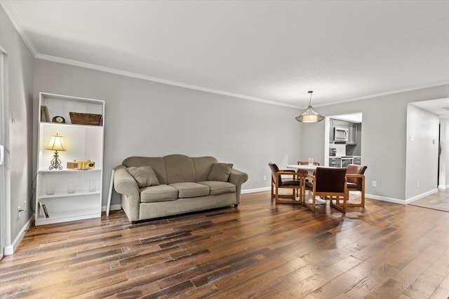 living room featuring dark hardwood / wood-style flooring and ornamental molding