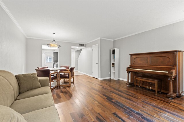 living room featuring dark hardwood / wood-style flooring and crown molding