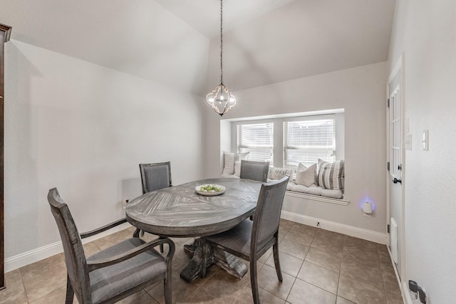 dining room featuring light tile patterned flooring and lofted ceiling