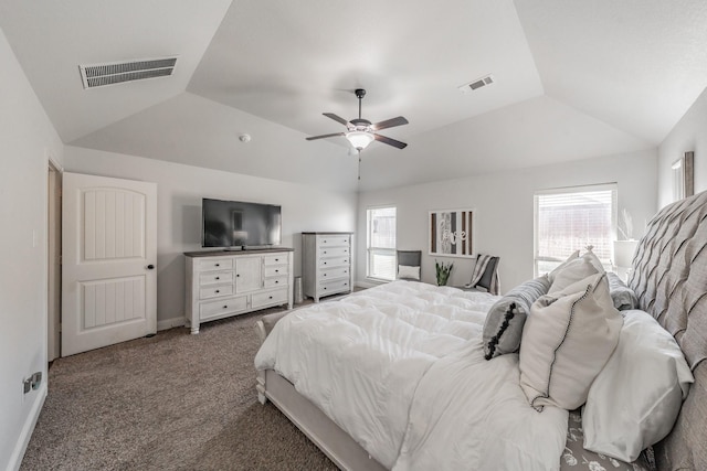 bedroom featuring vaulted ceiling, carpet, ceiling fan, and a tray ceiling