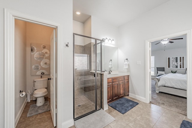 bathroom with a healthy amount of sunlight, vanity, a shower with shower door, and toilet