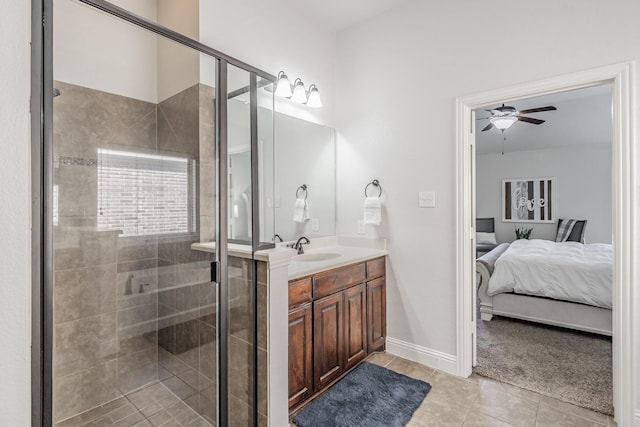 bathroom featuring tile patterned flooring, vanity, ceiling fan, and a shower with shower door