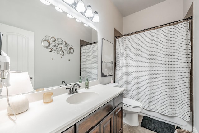 bathroom featuring tile patterned flooring, vanity, curtained shower, and toilet