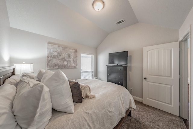 carpeted bedroom with lofted ceiling