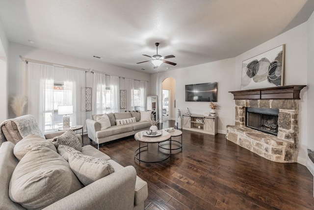 living room featuring a fireplace, dark hardwood / wood-style floors, and ceiling fan