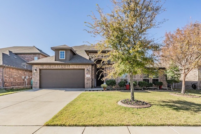 view of front of property with a garage and a front yard