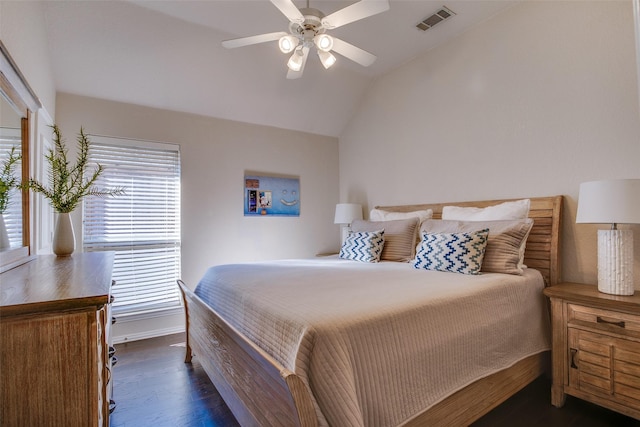 bedroom featuring ceiling fan, dark hardwood / wood-style flooring, and vaulted ceiling