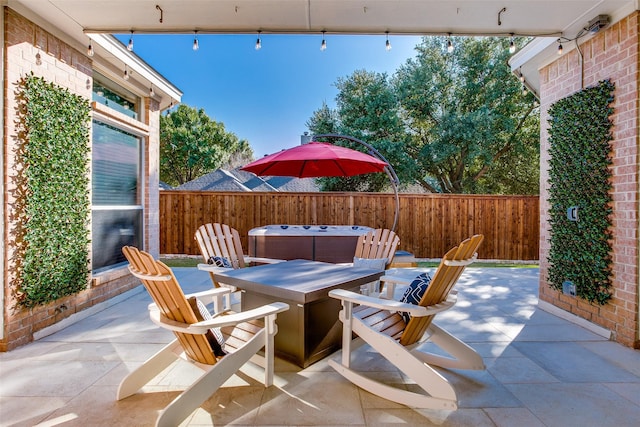 view of patio / terrace with a hot tub