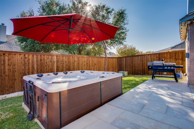 view of patio with a hot tub and a grill