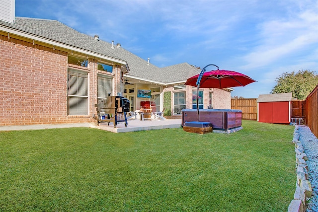 view of yard with a patio, a shed, and a hot tub