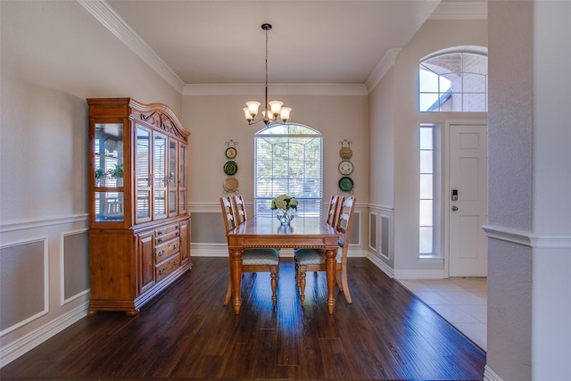 dining area with crown molding, dark hardwood / wood-style flooring, and plenty of natural light