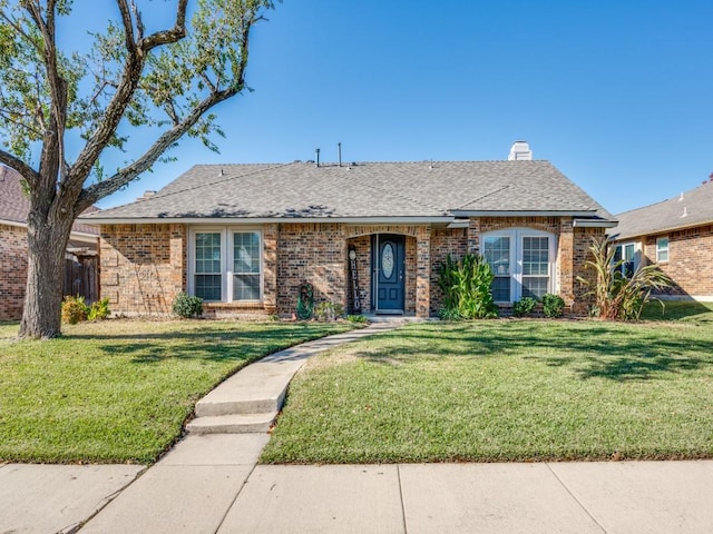 single story home featuring a front lawn