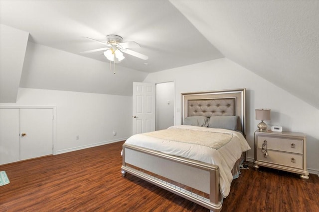 bedroom featuring ceiling fan, dark hardwood / wood-style flooring, and vaulted ceiling