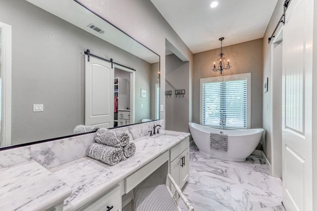 bathroom with a notable chandelier, a washtub, and vanity