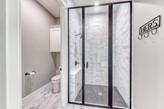 bathroom featuring toilet and a shower with shower door