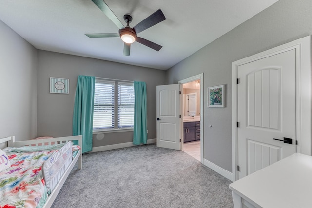 bedroom featuring light carpet, ensuite bath, and ceiling fan