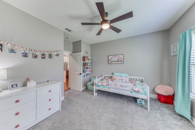 bedroom with ceiling fan and light carpet