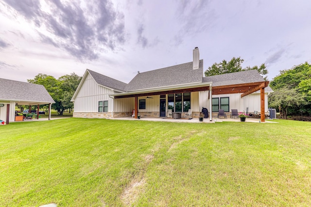 rear view of property featuring a lawn, ceiling fan, a patio area, and central AC