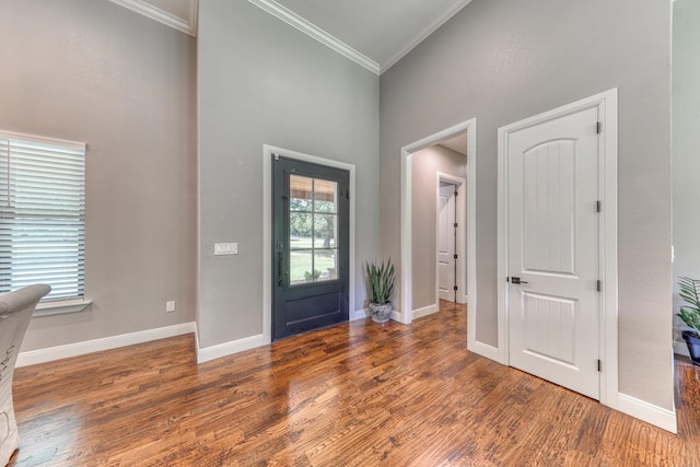 foyer featuring dark hardwood / wood-style floors and ornamental molding