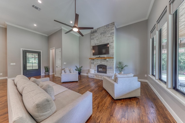 living room featuring crown molding, a fireplace, and dark hardwood / wood-style floors