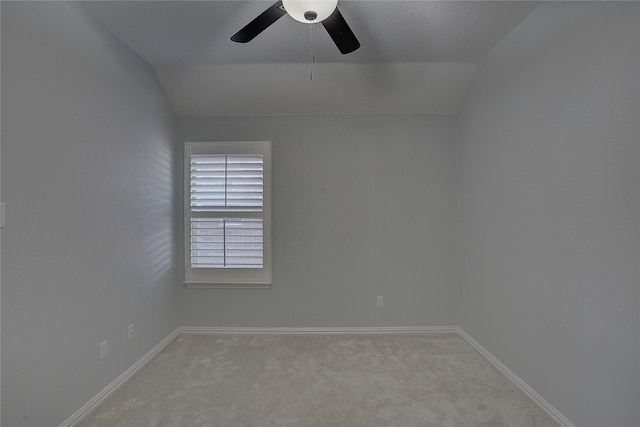 carpeted empty room featuring lofted ceiling and ceiling fan