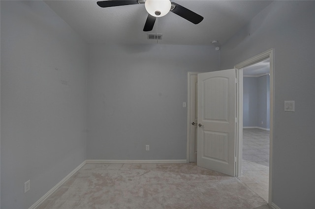 carpeted spare room with ceiling fan