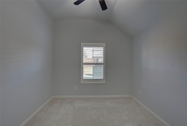 unfurnished room featuring light carpet, vaulted ceiling, and ceiling fan