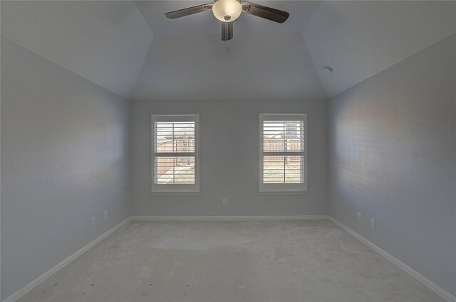 carpeted empty room featuring lofted ceiling and ceiling fan