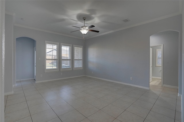 spare room with ceiling fan, ornamental molding, and light tile patterned floors