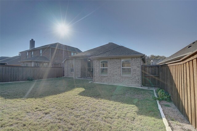 rear view of house with a yard