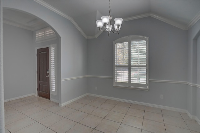 tiled empty room with a notable chandelier, ornamental molding, and lofted ceiling