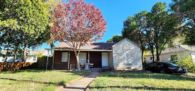 bungalow-style home featuring a porch and a front yard