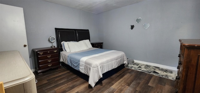 bedroom with dark wood-type flooring