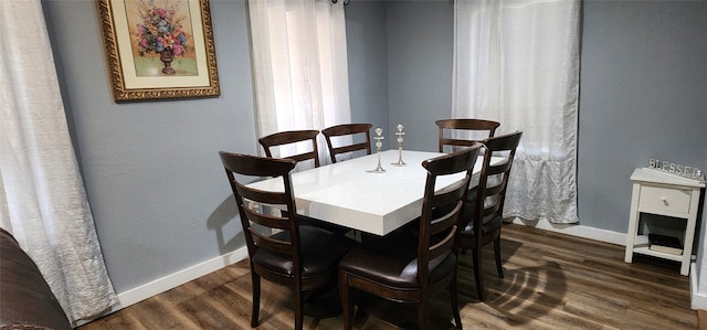 dining room with dark hardwood / wood-style flooring