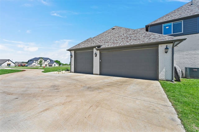 view of property exterior featuring cooling unit and a garage