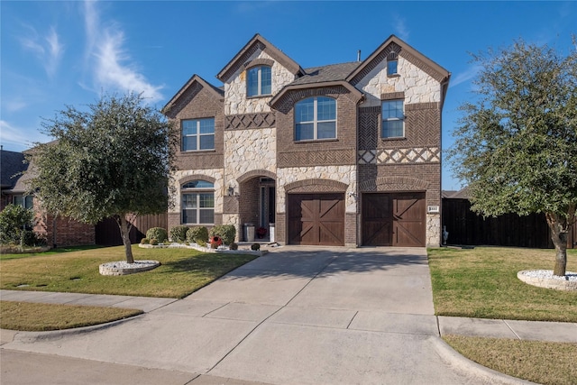 view of front facade with a garage and a front lawn