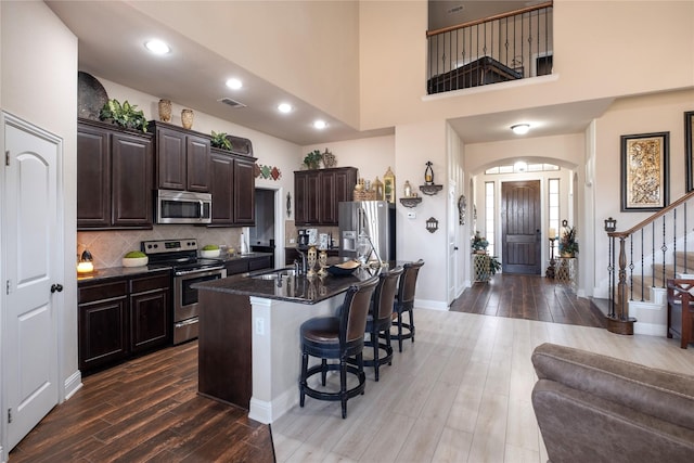 dining area featuring an inviting chandelier, dark hardwood / wood-style flooring, and vaulted ceiling