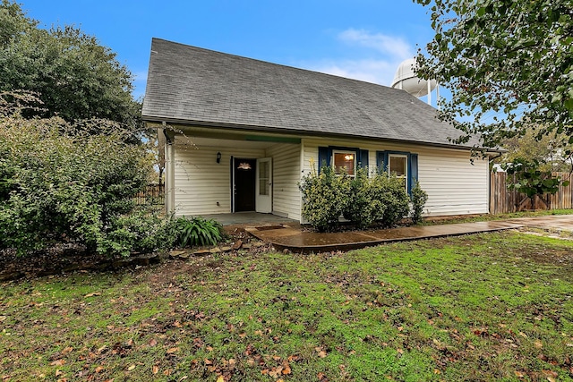 view of front of home with a patio and a front lawn