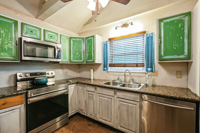 kitchen featuring dark wood-type flooring, sink, vaulted ceiling, appliances with stainless steel finishes, and ceiling fan