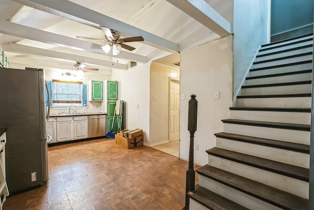 kitchen with stainless steel appliances, ceiling fan, sink, and beam ceiling