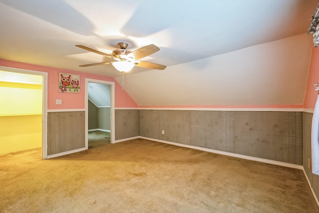 bonus room with vaulted ceiling, carpet, and ceiling fan