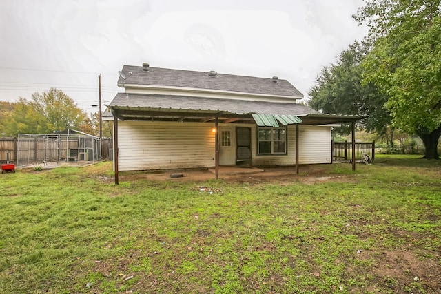 rear view of house with a lawn