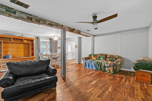 living room featuring wood-type flooring and ceiling fan