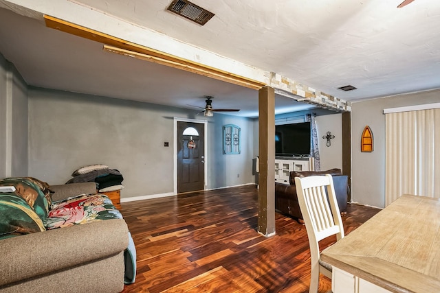 living room with ceiling fan and dark hardwood / wood-style flooring